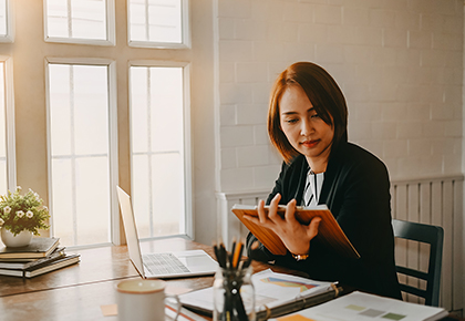 Woman in front of a computer reading a report