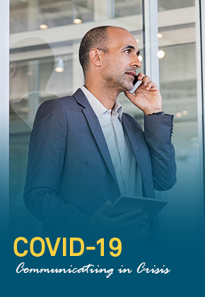 Manager talking on a cellphone while holding a tablet with the other hand