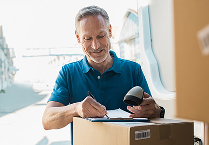 man signing for package