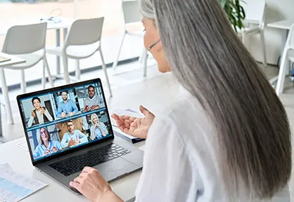 women on laptop with virtual meeting